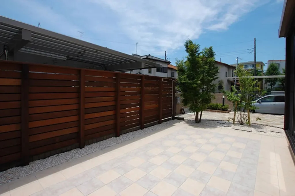 木製フェンスと庭木がある開放的な庭スペース